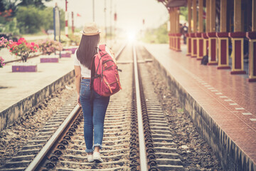  Young asian gril walking at train station before travel. work and travel concept.