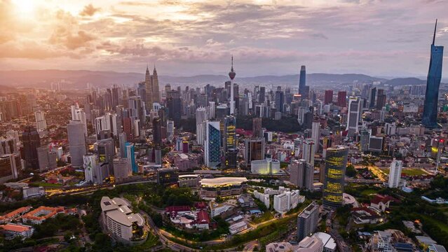 aerial view of Kuala Lumpur city, skyline in Federal Territory, MalaysiaKuala Lumpur Time Lapse, Traffic light trails and pedestrians near The Petronas Towers.