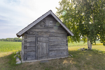 Rural landscape view of a 19th century log cabin on the prairie in midwestern United States