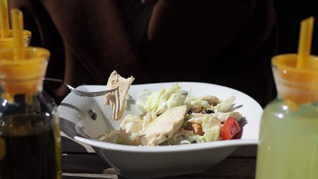 women eating vegetable salad with grilled chicken 