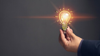 ideas concept. Man holding light bulb with starburst sparks. brainstorming ideas in a new way....