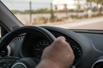 old man hands on steering wheel, driving car, road trip