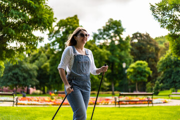 Nordic walking - woman training in city park
