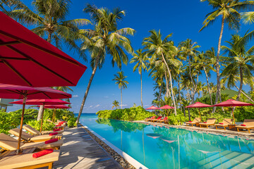 Panoramic vacation poolside landscape. Luxury beach resort hotel swimming pool, beach chairs beds, loungers under umbrellas with palm trees, blue sunny sky reflections. Summer island seaside, travel