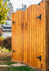 Entrance of house with beautiful new wooden gates. Gateway Background. Traditional wooden closed door gates.