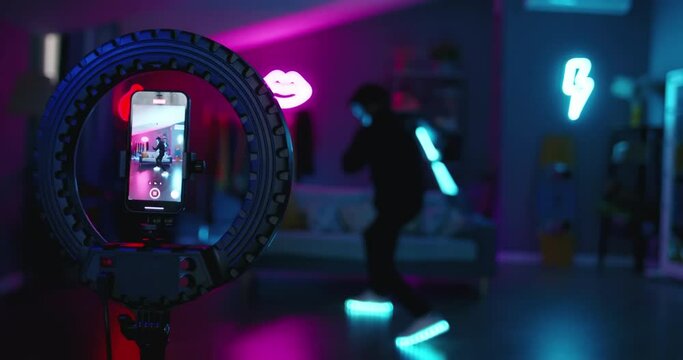 Two dancers record trending reels for social media channel. In halloween neon masks unknown unrecognizable. Trending moving dance reel tiktok instagram app youtuber Instagram reels youtube shorts