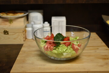 fresh cut vegetable salad and bottled vitamins