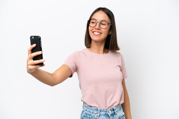 Fototapeta premium Young caucasian woman isolated on white background making a selfie
