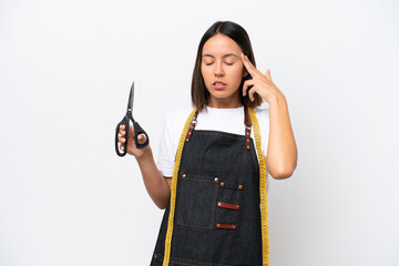 Young seamstress woman isolated on white background with headache