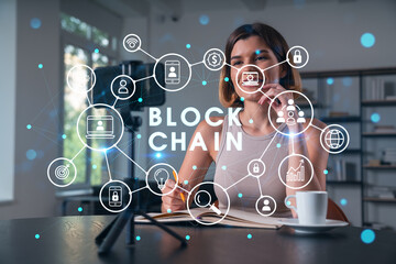 Happy woman is making video blog using smartphone on a tripod explaining with hands at office workplace. Concept of online stream, business education, conference call. Blockchain hologram