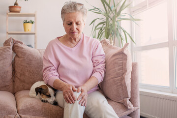 senior woman suffering from pain in leg