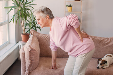 Upset mature woman suffering from backache