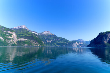Scenic view of mountain panorama with Lake Lucerne in the foreground on a sunny spring day. Photo taken May 22nd, 2023, Canton Uri, Switzerland.