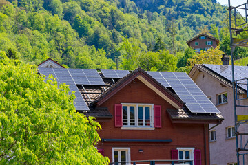 Pitched roof house with solar panels on rooftop at Swiss village of Sisikon, Canton Uri, Switzerland. Photo taken May 22nd, 2023, Sisikon, Switzerland.