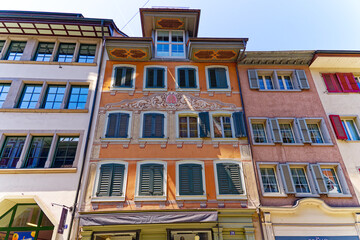 Fototapeta na wymiar Scenic view of facades of historic houses with decorations at the old town of Swiss City of Zug on a sunny spring day. Photo taken May 22nd, 2023, Zug, Switzerland.