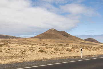 View of the strange, unfriendly but fascinating deserted landscape of the island volcanoes of the center of Fuerteventura. North part of the island.