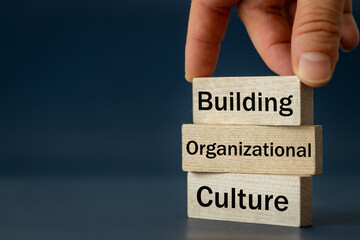 A wooden block with the words Building, Organizational, Culture, Modern approach to working with...