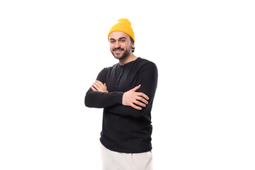 portrait of a young 30s authentic brunette male adult in a black sweater on a white background with copy space