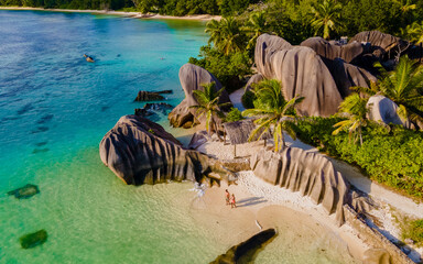 Anse Source d'Argent, La Digue Seychelles, a young couple of men and women on a tropical beach...