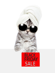 Cute kitten wearing sunglasses and towel on it head shows signboard with labeled "black friday sale" behind empty white banner. isolated on white background