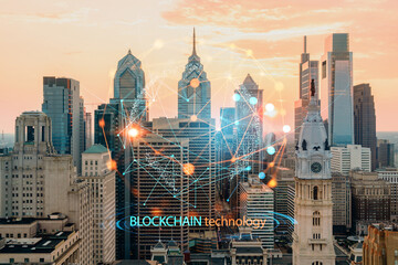Aerial panoramic skyline of Philadelphia financial downtown, Pennsylvania, USA. City Hall Clock Tower at sunset. Decentralized economy. Blockchain, cryptocurrency and cryptography concept, hologram