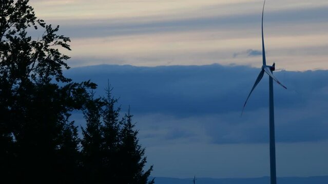 Wind turbine spinning in the wind during a sunset in the Black Forest
