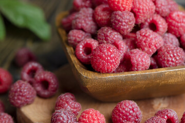 Ripe raspberries on a wooden board