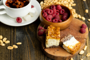 Cheesecake with chocolate sponge cake and peanuts in caramel