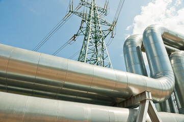 pipeline and power lines against the background of blue sky and clouds