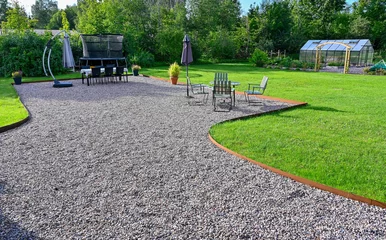 Foto op Canvas Back yard with seating area on gravel and lawn around © Jonas