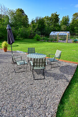 Back yard with seating area on gravel and lawn around