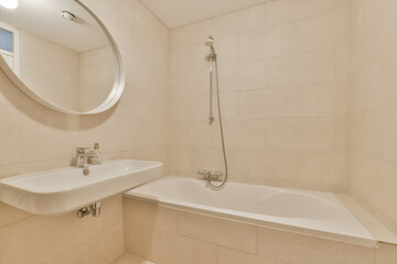 a bathroom with a sink, mirror and bathtub on the wall next to the tub in the shower stall
