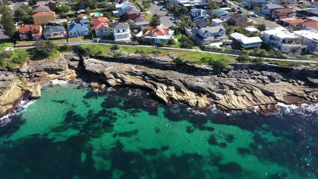Aerial drone view of Cronulla South revealing Cronulla Beach Ocean Pools in the Sutherland Shire, South Sydney, NSW Australia on a sunny day in July 2023  
