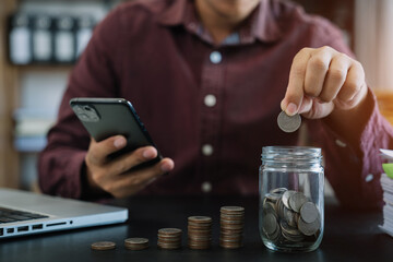 accountant working on desk in office using calculator and laptop to calculate budget. concept finance and accounting in morning light.