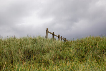Old Timber Fence Section Against an Overcast Sky at a Coastal Hillside Location