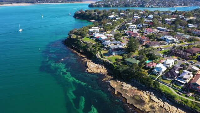 Aerial drone pullback reverse view of Cronulla South showing Bass and Flinders Point in the Sutherland Shire, South Sydney, NSW Australia on a sunny day in July 2023  
