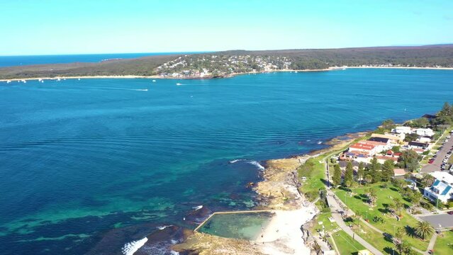 Aerial drone view of Cronulla South along Oak Park Beach and Rock Pool in the Sutherland Shire, South Sydney, NSW Australia looking south over Port Hacking on a sunny day in July 2023  