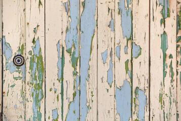 Peeling paint on wooden planks background. Old grunge texture.