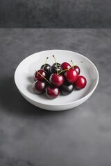 Fresh ripe black cherries in bowl on light gray stone background, concept of healthy eating and summer vegan food. Closeup, selective focus