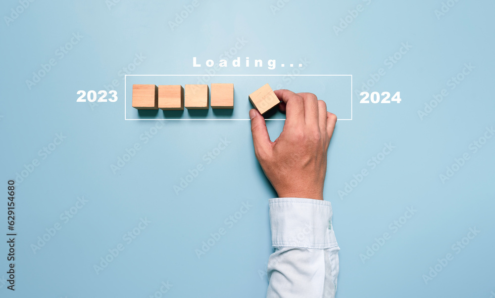 Poster businessman assembly wooden block in progress bar for loading new year 2023 to 2024 concept.
