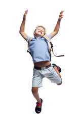 A boy with a backpack is jumping. Happy child in shorts and shirt. Back to school. Full height. Isolated on a white background. Vertical.