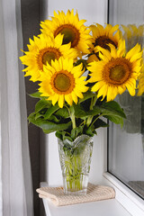 Still life with beautiful sunflowers bouquet in glass vase