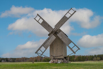 Fototapeta na wymiar Grain mill on the summer landscape. Windmill and natural background pattern. Hiiumaa, small island in Estonia.
