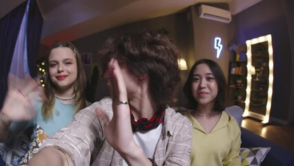 Group of multinational friends record videos. Bloggers shoot cheerful positive video for their blog on Internet. Collaboration of friends bloggers. Stories reels for online blog with bloggers friends