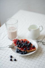 Fresh delicious breakfast with Coffee, crispy croissants, jam on white wooden background. Selective focus. Romantic french weekend concept.