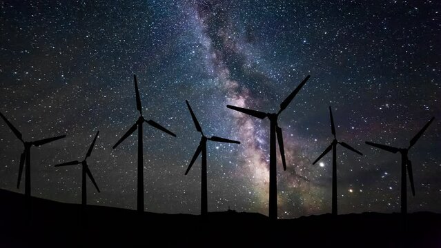 Wind turbines at night under the starry sky. Timelapse.