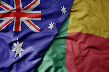 big waving realistic national colorful flag of australia and national flag of benin .