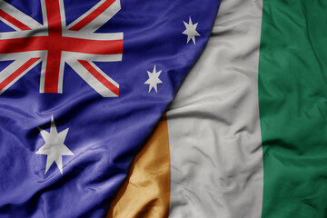 big waving realistic national colorful flag of australia and national flag of cote divoire .