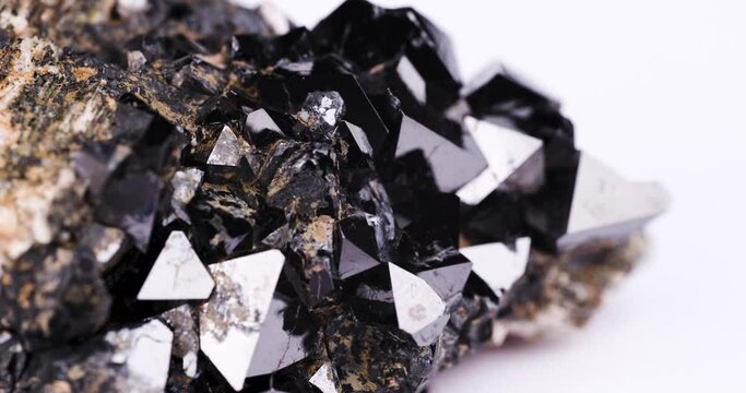magnetite crystal (natural magnet) rotating in 4k. macro detail texture background. close-up raw rough unpolished semi-precious gemstone