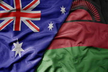 big waving realistic national colorful flag of australia and national flag of malawi .